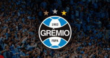 a gremio logo is displayed in front of a crowd of soccer fans