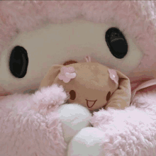 a stuffed animal with a flower on its head