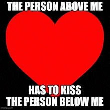 a red heart on a black background with the words `` the person above me has to kiss the person below me '' .