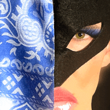 a close up of a woman wearing a mask and a blue bandana