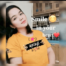 a woman wearing a yellow shirt with the words smile in your heart on it