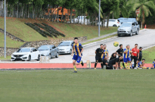 a group of soccer players on a field with one wearing a red jersey that says ' allianz ' on the front