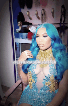 a woman with blue hair is wearing a blue and gold dress with the hashtag getheriasdaughter on the bottom