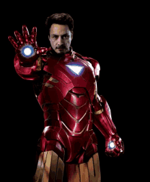 a man in a red iron man suit with a light on his arm