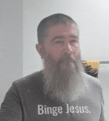 a man with a beard wearing a binge jesus shirt