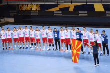 a group of athletes are standing in front of a sign that says champions