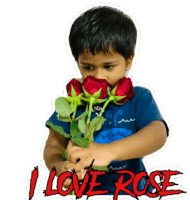 a young boy is holding a bouquet of red roses with a sticker that says ' i love rose '