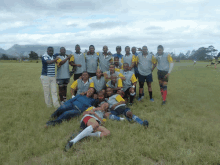 a group of people posing for a picture in a grassy field