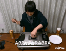 a person cooking on a grill with abracadabra written on the bottom