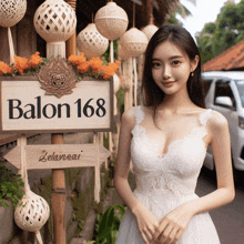 a woman stands in front of a sign that says balon 168