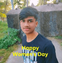 a young man wearing a black shirt with the words happy women 's day on it