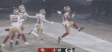 a football game between the 49ers and the green bay packers is being played in the rain