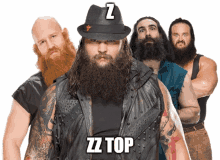 a group of bearded men are standing next to each other and one of them is wearing a hat with a z on it