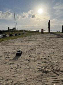 a remote controlled car is sitting in the sand on a beach