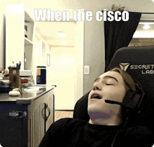 a man wearing a headset is laying in a secret lab chair with his eyes closed