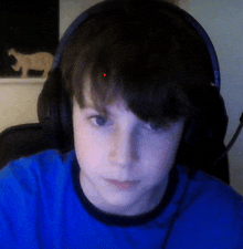 a boy wearing headphones and a blue shirt