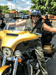 a man wearing a helmet and goggles rides a motorcycle