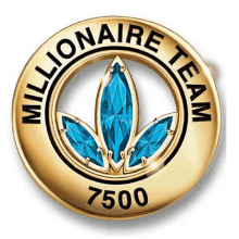 a gold millionaire team badge with blue stones in the center