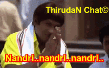 a man in a yellow shirt with a white towel around his neck says nandri.nandri.nandri