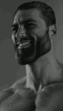 a black and white photo of a man with a beard smiling