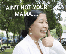 a woman giving a thumbs up with the words " ain 't not your mama " above her