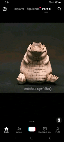 a phone screen shows a statue of a crocodile with the words saluden a pablito on it