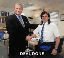 a man in a mullet shakes hands with a man in a suit and tie