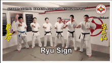 a group of men in karate uniforms are standing in a room with the words ryu sign on the bottom