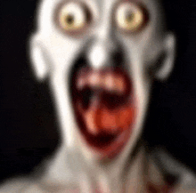 a blurry picture of a zombie with a bloody mouth and big eyes .