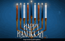 a picture of a menorah that says happy hanukkah on it