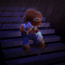 mario is sitting on the stairs in the rain covering his face .