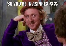 a man in a purple suit and top hat says " so you 're in aspire ?? "