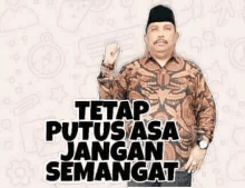 a man in a batik shirt is standing in front of a sticker that says `` tetap putus asa jangan semangat ''