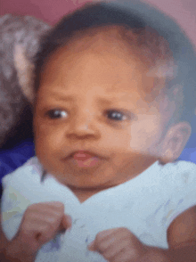 a close up of a baby 's face looking at the camera