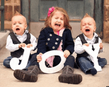 a girl is crying while two boys are crying while holding the word joy