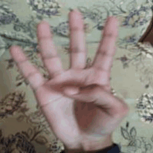 a close up of a person 's hand showing the number four .