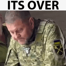 a man in a military uniform with the words it 's over behind him