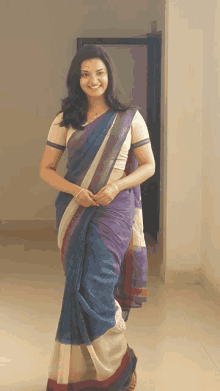 a woman wearing a blue and white striped saree