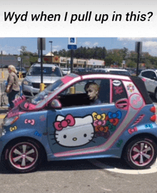 a smart car with a hello kitty design on the side