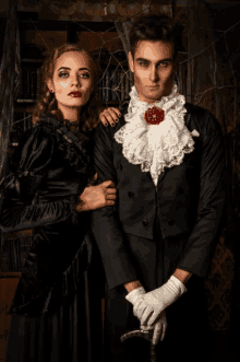 a man and a woman are dressed up as vampires