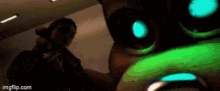 a close up of a person 's face with a green light coming out of it .