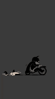 a black cat is riding a motorcycle next to a dog laying on the ground .