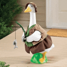 a stuffed duck dressed as a fisherman is holding a fishing rod and a fish