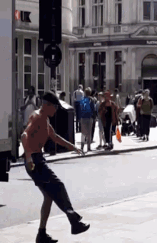 a man is doing a trick on the street in front of a building that has the word uk on it