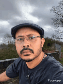 a man wearing glasses and a hat with faceapp written on the bottom right