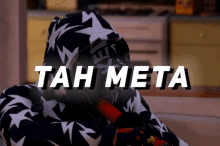 a person in a black and white hoodie with the words tah meta written on the bottom