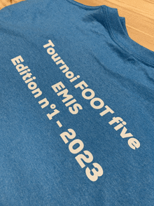 a blue shirt that says tournei foot five ems edition n ° 1 2023