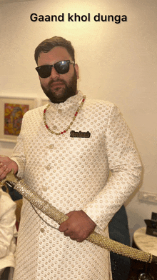 a man with a beard wearing sunglasses and holding a sword with a caption that says gaand khol dunga