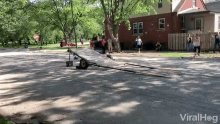 a trailer is sitting on the side of the road in front of a brick house and a stop sign