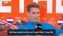 a man in a blue jacket is talking into a microphone and says well they tested my dna and it wasn t